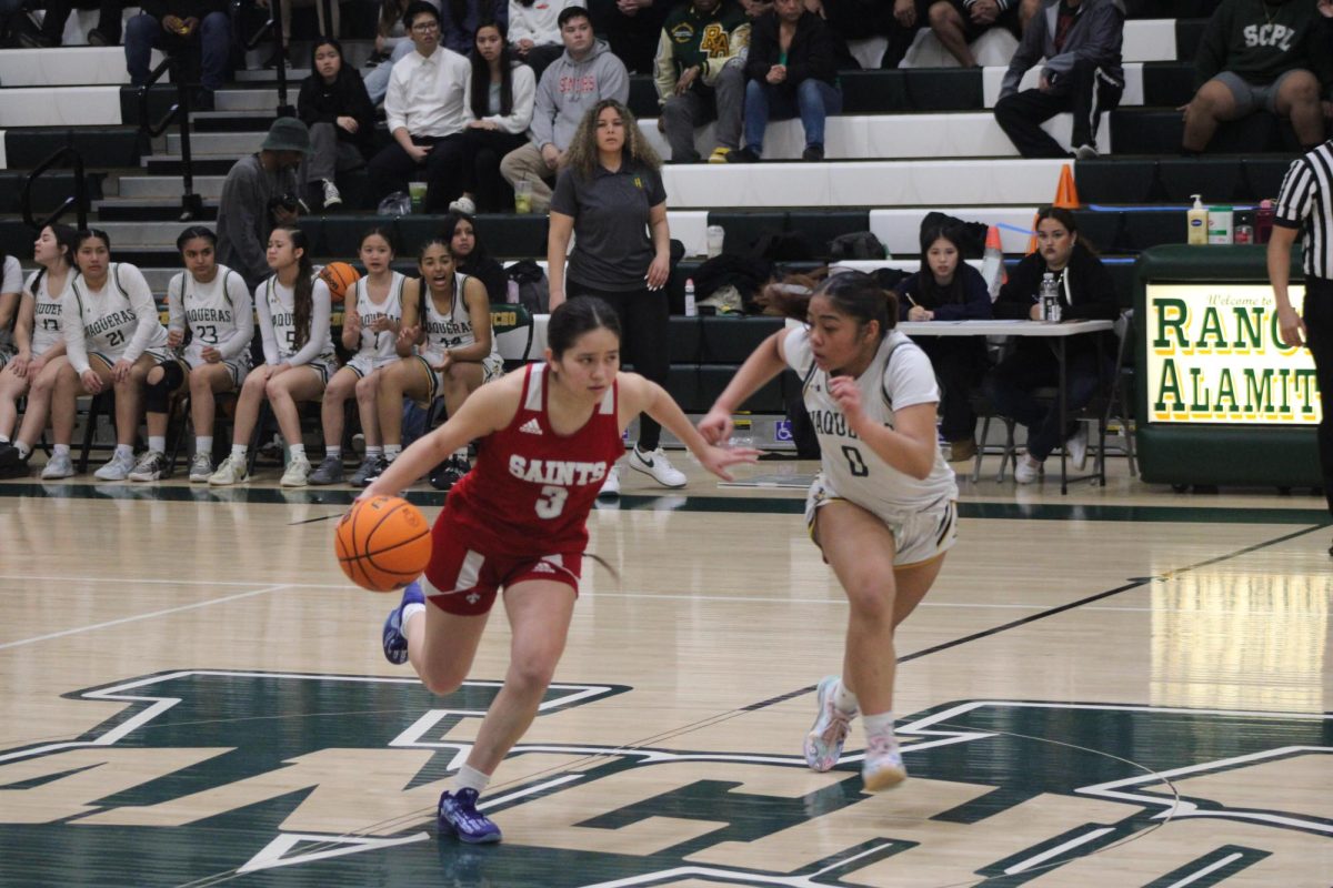 Yarexy Diaz drives for the Saints during the CIF-SS Div. 5 AA quarterfinals, Feb. 19. Santa Ana defeated Rancho Alamitos on the road, 48-27. 